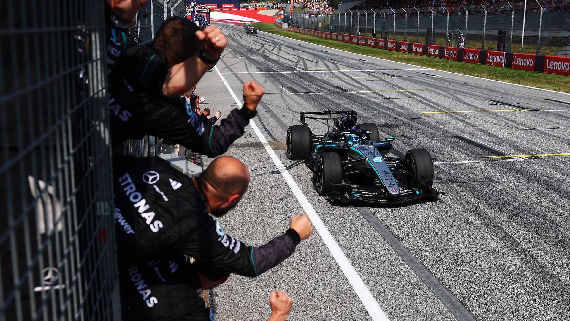 George Russell celebrating with the Mercedes-AMG PETRONAS team