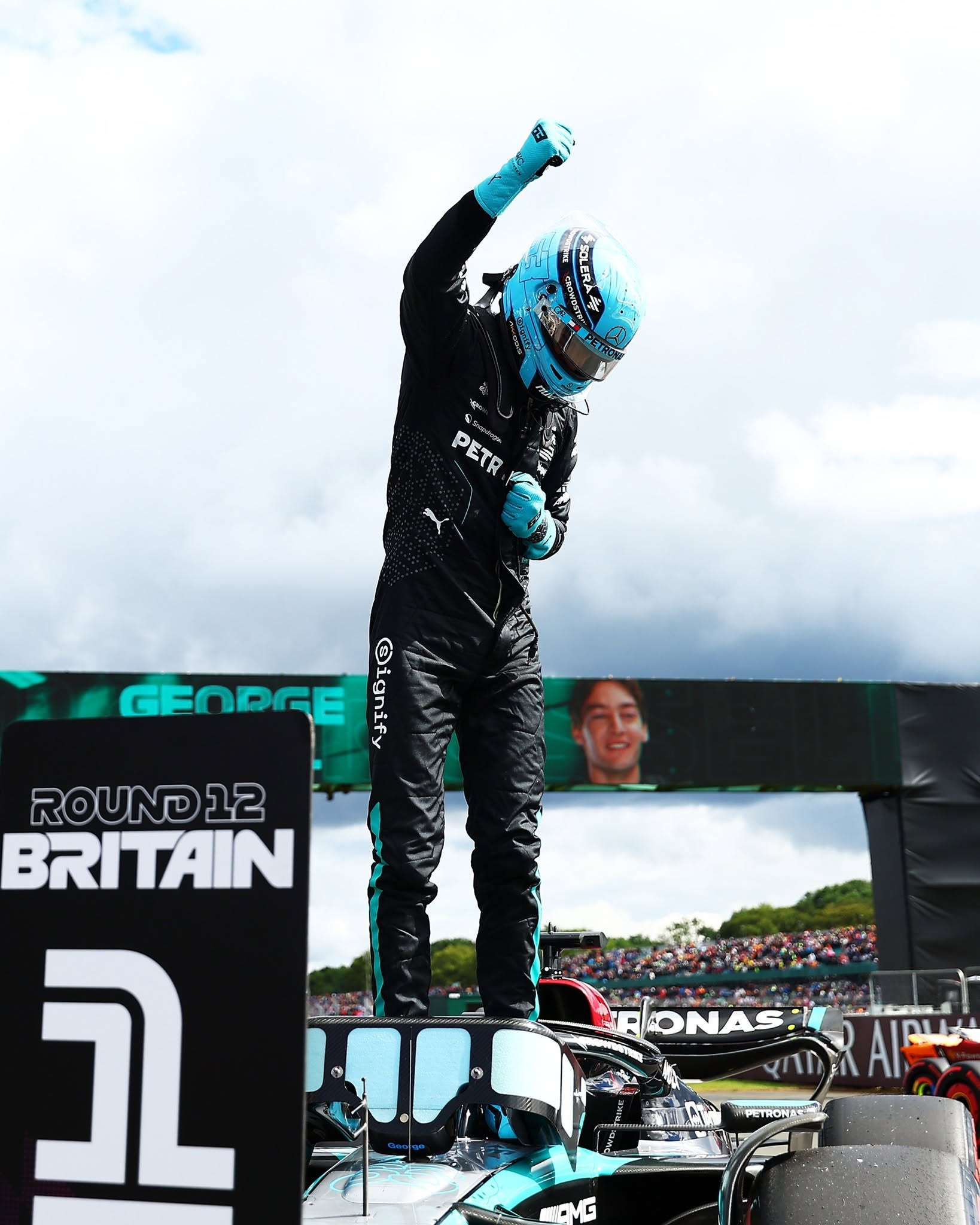 George Russell celebrating on his car after the British Grand Prix